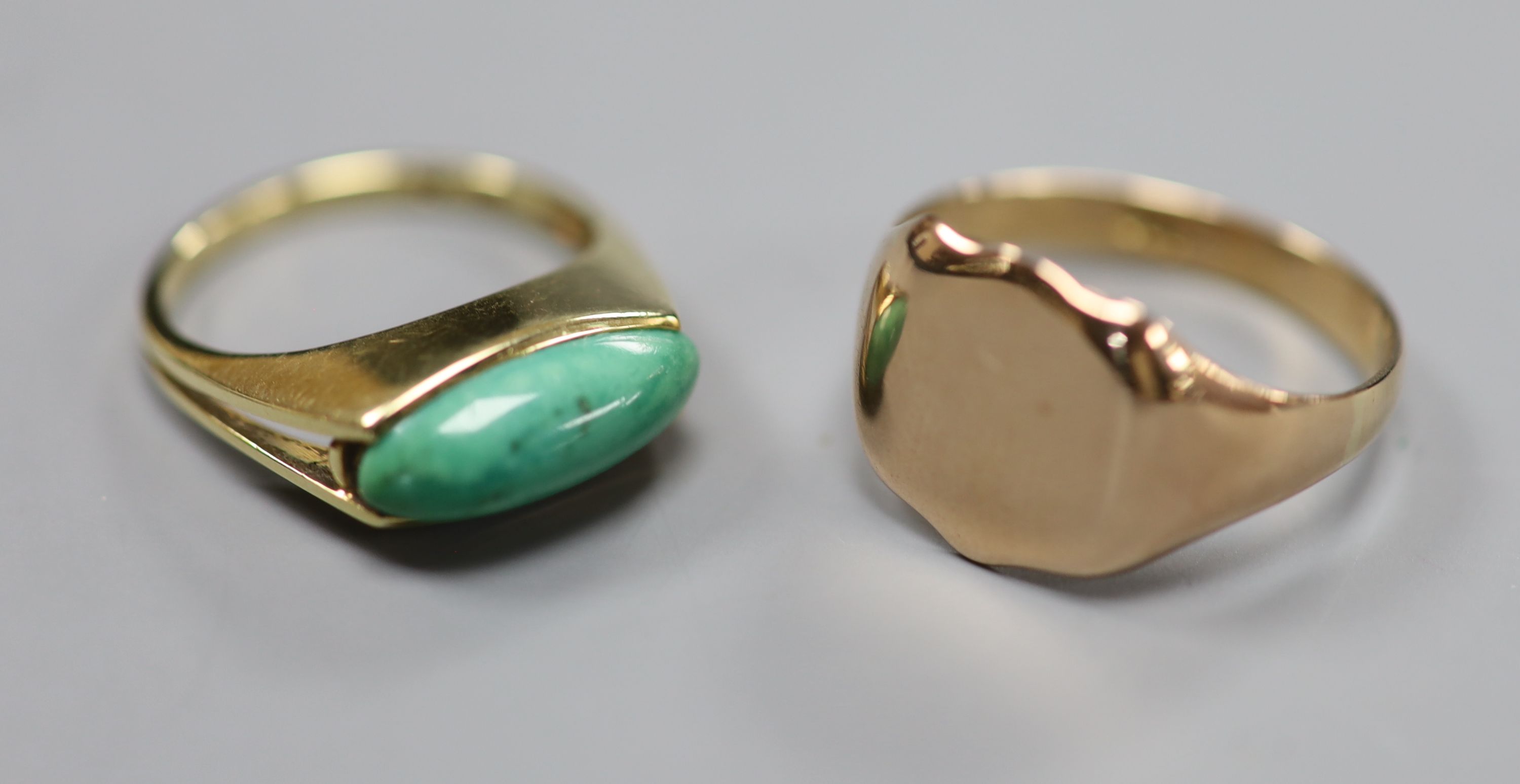 A 9ct signet ring, size T, gross 4.6 grams and a 585 yellow metal and turquoise? set ring, size O, gross 3.8 grams.